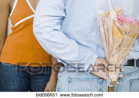African man surprising girlfriend with flowers View Large Photo Image Stock Image - African man surprising girlfriend with flowers. Fotosearch