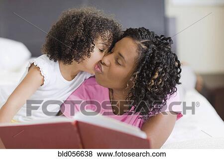African mother and daughter kissing on cheek View Large Photo Image Stock Photo - African mother and daughter kissing on cheek. Fotosearch