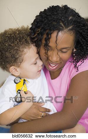 Stock Image - African mother hugging child. Fotosearch
