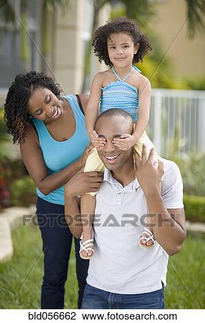 African mother watching daughter cover father’s eyes View Large Photo Image Stock Image - African mother watching daughter cover father’s eyes. Fotosearch