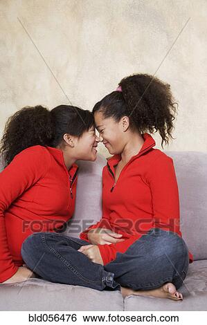 African twin sisters rubbing noses View Large Photo Image Stock Photograph - African twin sisters rubbing noses. Fotosearch
