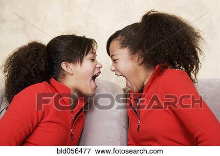 African twin sisters yelling View Large Photo Image Stock Photo - African twin sisters yelling. Fotosearch