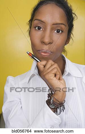 Picture - African woman holding pen. Fotosearch