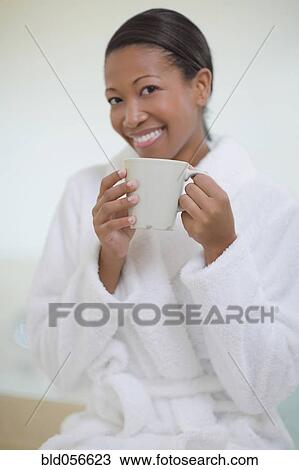 African woman in bathrobe drinking coffee View Large Photo Image Stock Image - African woman in bathrobe drinking coffee. Fotosearch