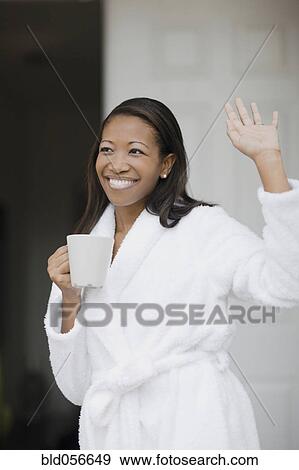 Stock Photo - African woman in bathrobe waving. Fotosearch