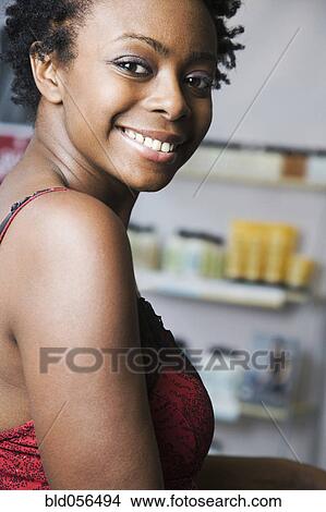 African woman looking over shoulder View Large Photo Image Picture - African woman looking over shoulder. Fotosearch