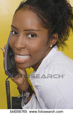 African woman talking on telephone View Large Photo Image Stock Photography - African woman talking on telephone. Fotosearch