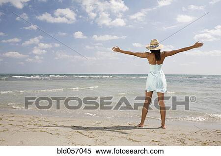 African woman with arms outstretched at beach View Large Photo Image Stock Photography - African woman with arms outstretched at beach. Fotosearch