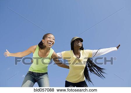 Stock Photo - African women with arms outstretched. Fotosearch