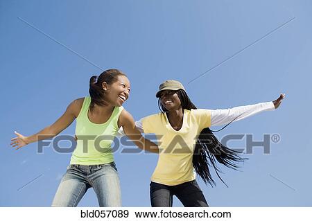 Stock Photo - African women with arms outstretched. Fotosearch