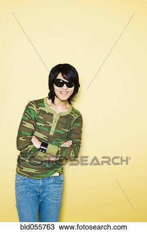 Stock Image - Asian man with arms crossed. Fotosearch