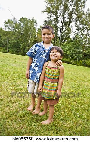Asian siblings with bare feet outdoors View Large Photo Image Stock Photo - Asian siblings with bare feet outdoors. Fotosearch