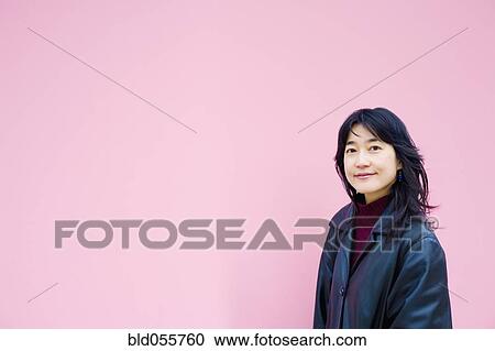 Stock Image - Asian woman wearing jacket. Fotosearch