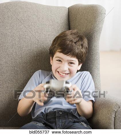 Hispanic boy playing video games View Large Photo Image Stock Photo - Hispanic boy playing video games. Fotosearch