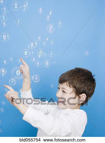 Hispanic boy popping bubbles View Large Photo Image Picture - Hispanic boy popping bubbles. Fotosearch