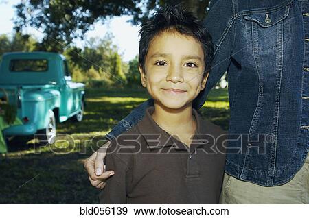 Hispanic boy with truck in background View Large Photo Image Stock Photo - Hispanic boy with truck in background. Fotosearch