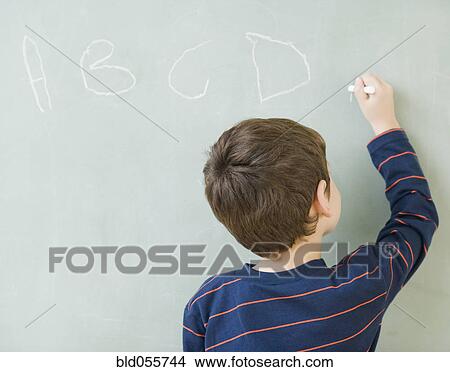 Hispanic boy writing on blackboard View Large Photo Image Picture - Hispanic boy writing on blackboard. Fotosearch
