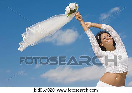 Hispanic bride holding bouquet over head View Large Photo Image Stock Image - Hispanic bride holding bouquet over head. Fotosearch