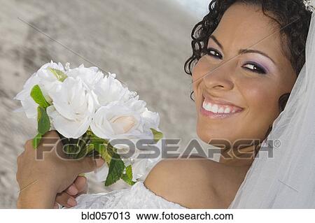 Hispanic bride holding bouquet View Large Photo Image Stock Image - Hispanic bride holding bouquet. Fotosearch