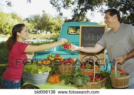 Hispanic couple at organic farm stand View Large Photo Image Stock Photo - Hispanic couple at organic farm stand. Fotosearch
