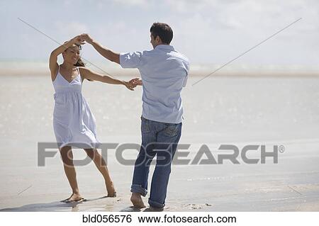 Stock Photograph - Hispanic couple dancing at beach. Fotosearch