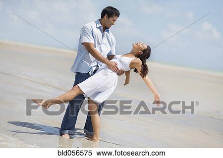Stock Photography - Hispanic couple dancing at beach. Fotosearch