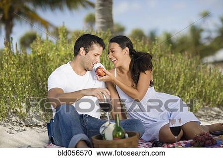 Stock Image - Hispanic couple having picnic. Fotosearch