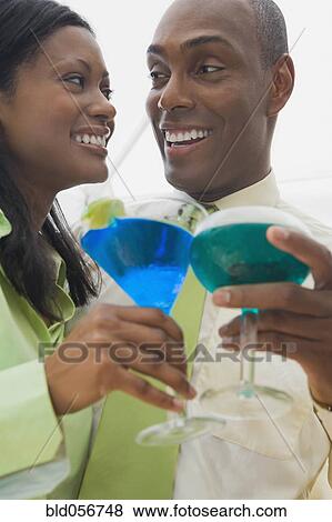 Hispanic couple holding cocktails View Large Photo Image Stock Photo - Hispanic couple holding cocktails. Fotosearch