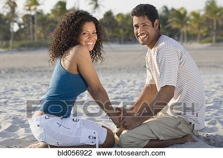 Hispanic couple holding hands at beach View Large Photo Image Stock Image - Hispanic couple holding hands at beach. Fotosearch