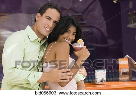 Hispanic couple hugging at bar View Large Photo Image Stock Image - Hispanic couple hugging at bar. Fotosearch