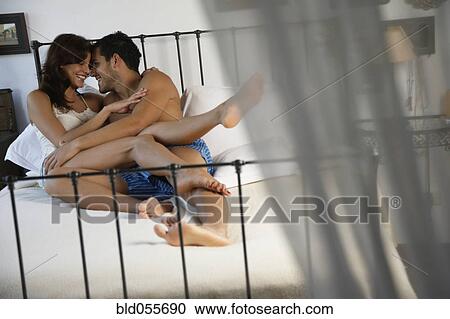 Hispanic couple hugging in bed View Large Photo Image Stock Image - Hispanic couple hugging in bed. Fotosearch