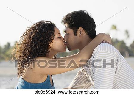 Picture - Hispanic couple kissing. Fotosearch
