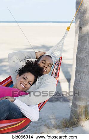 Hispanic couple laying in hammock View Large Photo Image Picture - Hispanic couple laying in hammock. Fotosearch