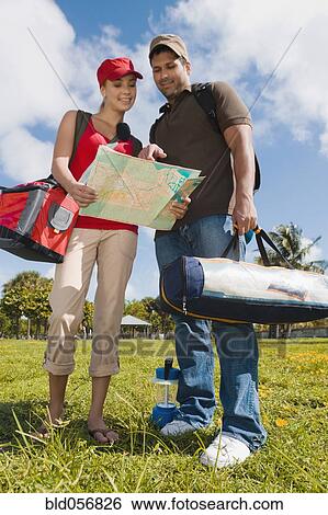 Stock Photograph - Hispanic couple looking at map. Fotosearch