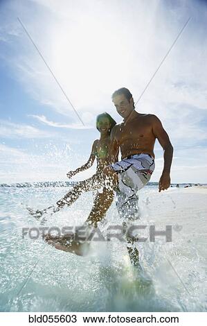 Hispanic couple splashing water View Large Photo Image Stock Image - Hispanic couple splashing water. Fotosearch