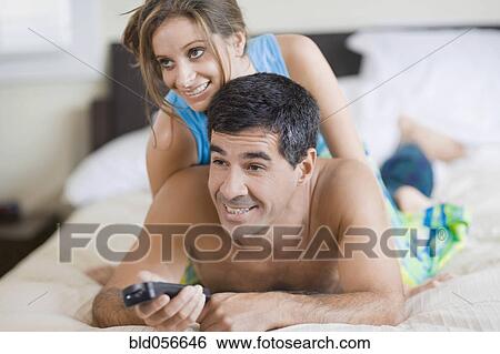 Stock Photograph - Hispanic couple watching television. Fotosearch