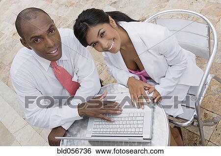 Hispanic couple with laptop at cafe View Large Photo Image Stock Photograph - Hispanic couple with laptop at cafe. Fotosearch
