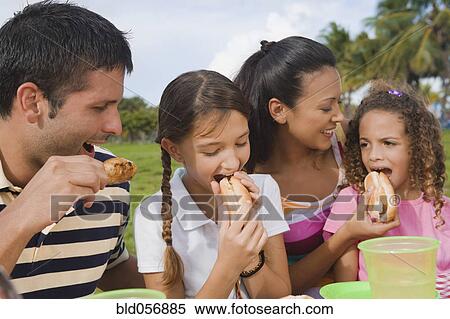 Stock Photography - Hispanic family eating outdoors. Fotosearch
