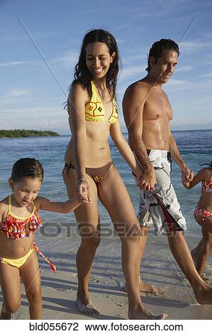 Hispanic family holding hands at beach View Large Photo Image Stock Image - Hispanic family holding hands at beach. Fotosearch