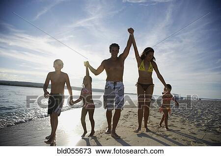 Hispanic family holding hands at beach View Large Photo Image Stock Image - Hispanic family holding hands at beach. Fotosearch