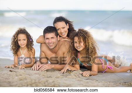Hispanic family laying on beach View Large Photo Image Picture - Hispanic family laying on beach. Fotosearch