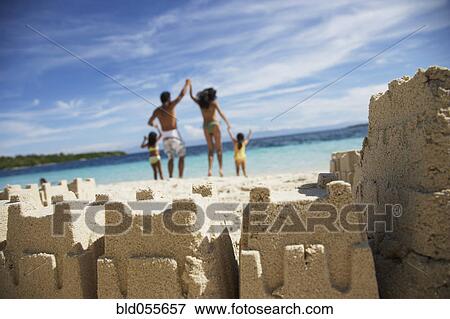 Hispanic family with sand castle in foreground View Large Photo Image Stock Photo - Hispanic family with sand castle in foreground. Fotosearch
