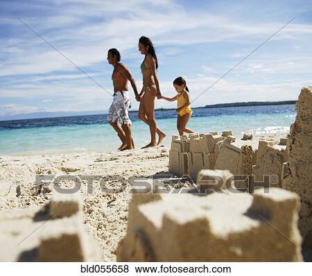 Hispanic family with sand castle in foreground View Large Photo Image Stock Photo - Hispanic family with sand castle in foreground. Fotosearch
