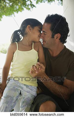 Picture - Hispanic father and daughter hugging. Fotosearch