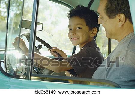 Hispanic father and son sitting in truck View Large Photo Image Stock Photo - Hispanic father and son sitting in truck. Fotosearch