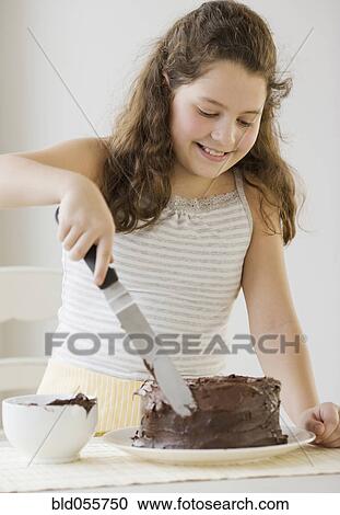 Hispanic girl icing cake View Large Photo Image Stock Image - Hispanic girl icing cake. Fotosearch