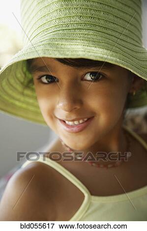 Stock Photo - Hispanic girl wearing hat. Fotosearch