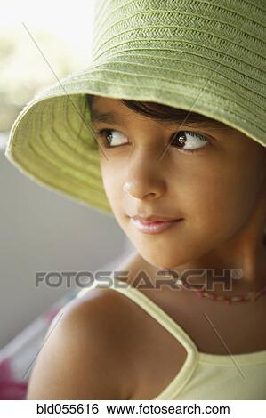 Stock Photograph - Hispanic girl wearing hat. Fotosearch