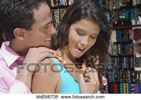 Hispanic man fastening necklace for girlfriend View Large Photo Image Stock Photography - Hispanic man fastening necklace for girlfriend. Fotosearch