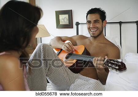 Hispanic man playing guitar for girlfriend View Large Photo Image Stock Photo - Hispanic man playing guitar for girlfriend. Fotosearch